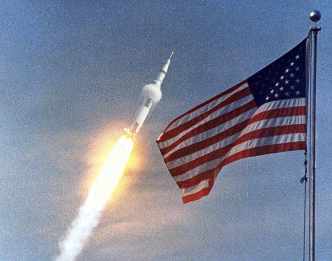 Apollo-11-Saturn-V-rocket-lifts-off-from-Kennedy-Space-Center-Launch-Complex-39A-July-16-1969-in-front-of-U.S.-flag-NASA-photo-posted-on-SpaceFlight-Insider-647x508