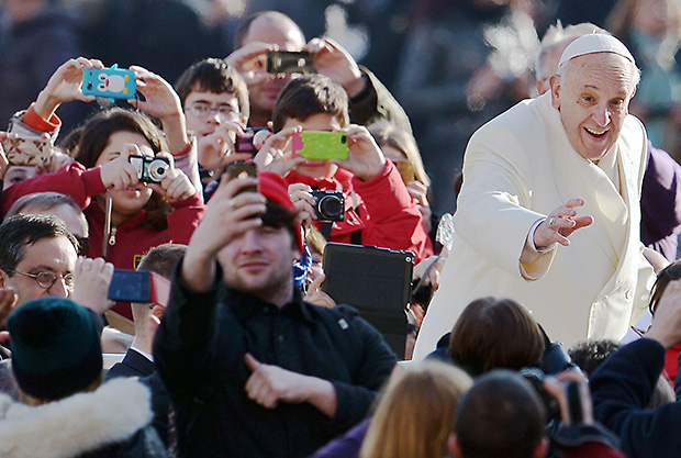 Pope Francis waves to faithfulls as he arrives at St Peter's Square at the Vatican to lead his weekly general audience on January 8, 2014.   AFP PHOTO/ Gabriel BOUYSGABRIEL BOUYS/AFP/Getty Images
