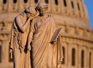 A statue at the U.S. Capitol is seen at sunset following the shooting at the Washington Navy Yard, Monday, Sept. 16, 2013, in Washington.  (AP Photo/J. Scott Applewhite)