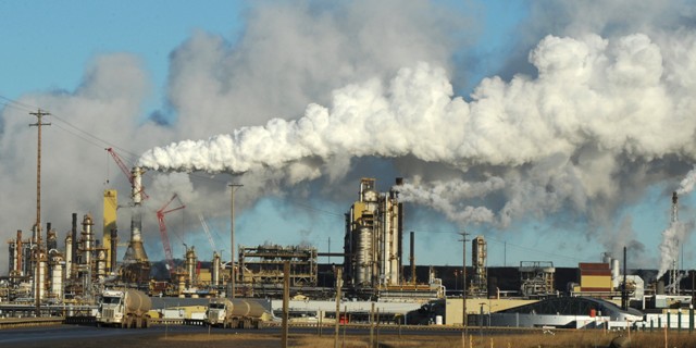 View of the Syncrude oil sands extraction facility near the town of Fort McMurray in Alberta Province, Canada on October 25, 2009.  Greenpeace is calling for an end to oil sands mining in the region due to their greenhouse gas emissions and have recently staged sit-ins which briefly halted production at several mines. At an estimated 175 billion barrels, Alberta's oil sands are the second largest oil reserve in the world behind Saudi Arabia, but they were neglected for years, except by local companies, because of high extraction costs. Since 2000, skyrocketing crude oil prices and improved extraction methods have made exploitation more economical, and have lured several multinational oil companies to mine the sands.            AFP PHOTO/Mark RALSTON (Photo credit should read MARK RALSTON/AFP/Getty Images)