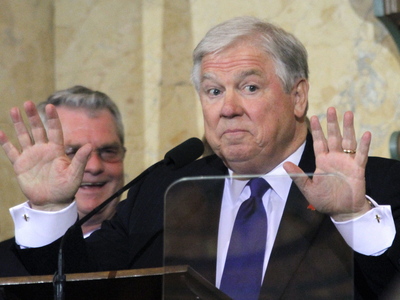Gov. Haley Barbour gestures to lawmakers that they take their seats and cease their applause so he can deliver his eighth and final State of the State address to a joint Legislature in House Chambers at the Capitol in Jackson, Miss., Tuesday, Jan. 11, 2011. (AP Photo/Rogelio V. Solis)