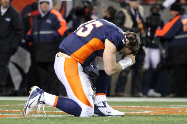 Denver Broncos quarterback Tim Tebow prays after the Broncos defeated the Pittsburgh Steelers in overtime in the NFL AFC wildcard playoff football game in Denver, Colorado, January 8, 2012. REUTERS/Marc Piscotty (UNITED STATES  - Tags: SPORT FOOTBALL)