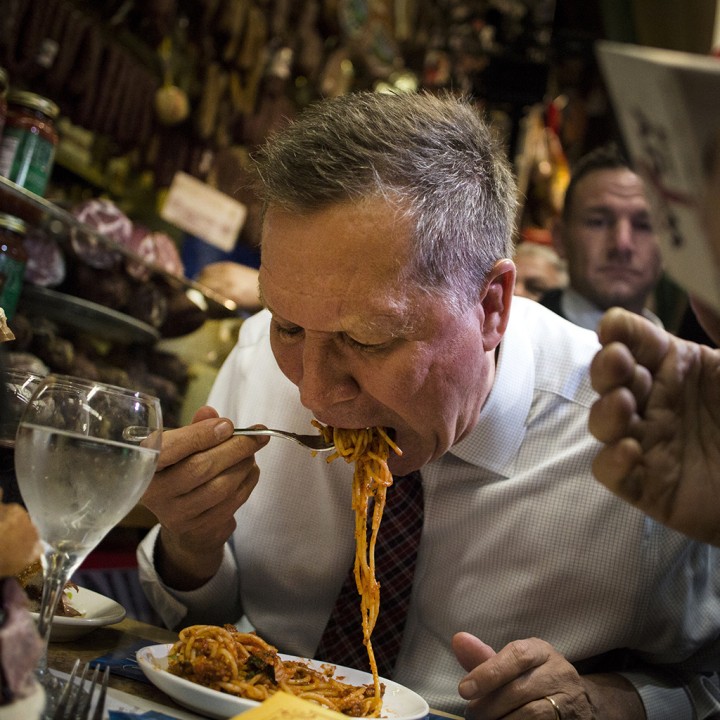 John Kasich, governor of Ohio and 2016 Republican presidential candidate, eats pasta at Mike's Deli during a campaign stop in the Bronx borough of New York, U.S., on Thursday, April 7, 2016. Kasich, the third Republican in the race, has only won his home state and was lagging well behind Trump and Cruz in Wisconsin polls. Photographer: John Taggart/Bloomberg via Getty Images