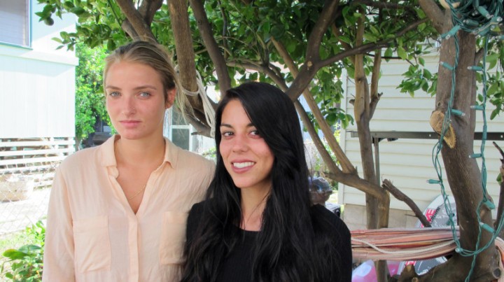 File-This Oct. 28, 2015, file photo shows Courtney Wilson, left, and Taylor Guerrero posing for a photo in Honolulu.  Honolulu will pay $80,000 to settle a lesbian couple's lawsuit alleging a city's police officer wrongfully arrested them after seeing them kissing in a grocery store while on vacation. The settlement was announced Friday, May 20, 2016, in federal court in Honolulu. It's still subject to City Council approval. Wilson and  Guerrero were visiting Hawaii form Los Angeles last year when they say they were harassed and arrested because the officer didn't like their public displays of affection in a Foodland store on Oahu's North Shore. (AP Photo/Jennifer Sinco Kelleher, File)