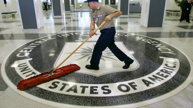 FILE - In this March 3, 2005 file photo, a workman slides a dustmop over the floor at the Central Intelligence Agency headquarters in Langley, Va. Senate investigators have delivered a damning indictment of CIA interrogation practices after the 9/11 attacks, accusing the agency of inflicting pain and suffering on prisoners with tactics that went well beyond legal limits. The torture report released Tuesday by the Senate Intelligence Committee says the CIA deceived the nation with its insistence that the harsh interrogation tactics had saved lives. It says those claims are unsubstantiated by the CIA's own records. (AP Photo/J. Scott Applewhite)