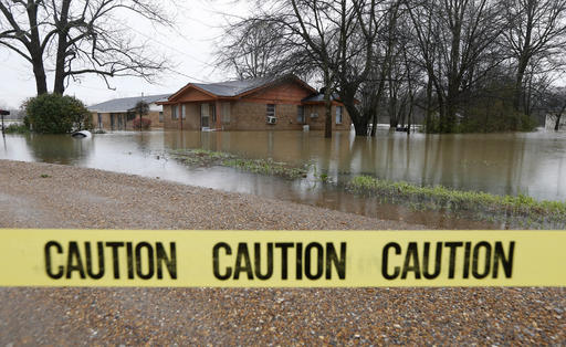 Caution tape closes off this neighborhood in Drew, Miss., Friday, March 11, 2016, as floodwaters have affected areas in the Delta. The flooding has affected the Delta to varying degrees. Additional rain is expected to continue through Saturday. (AP Photo/Rogelio V. Solis)