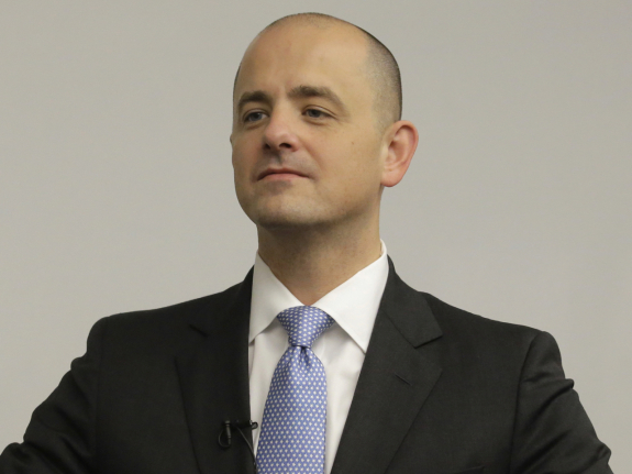 In this Aug. 27, 2016 photo, Evan McMullin, an independent presidential candidate, adjusts his jacket during a staff meeting near Salt Lake City. McMullin, a Brigham Young University graduate, former CIA officer, investment banker and congressional aide, is running as a third-party conservative. (AP Photo/Rick Bowmer)