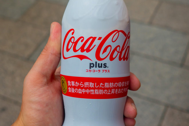 KEHT8K TOKYO, JAPAN -28 JUN 2017: Hand holding the new Coca Cola Plus, now available in some vending machines in Japan. Throughout Japan, This new Coca Cola Contains ingredients that nourish the body and health in Tokyo
