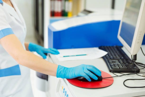 2214628-scientist-entering-data-of-blood-sample-in-computer-at-laboratory