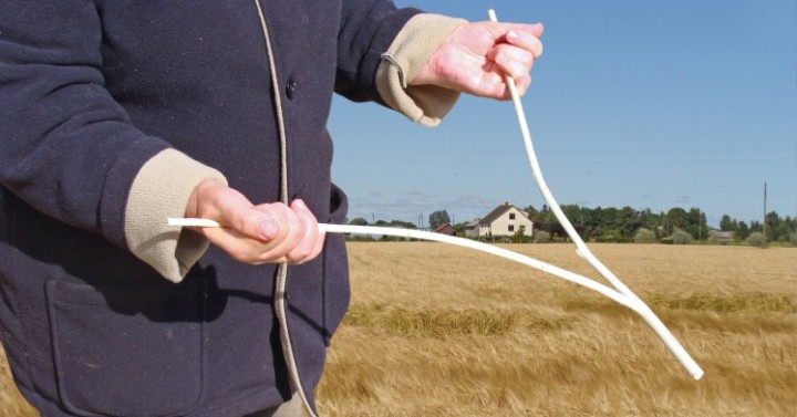 Searching underground water with wooden dowsing or divining rod                               ; Shutterstock ID 720883450; Purchase Order: -